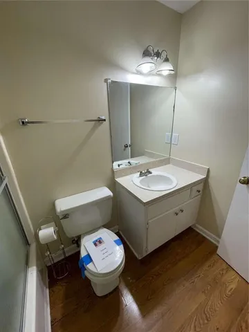 a bathroom with a sink a toilet and a mirror