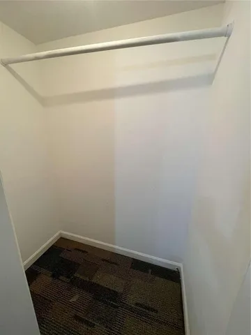 an entryway view with wooden floor and a hallway