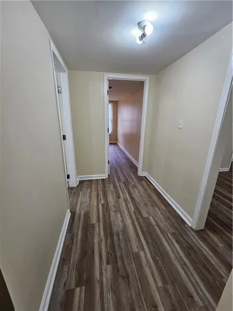 a view of a room with wooden floor and staircase