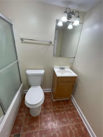 a bathroom with a toilet a sink and mirror
