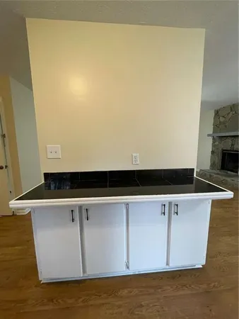 a view of a white refrigerator with wooden floor