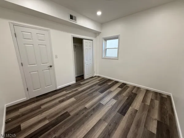 a view of a room with wooden floor and closet