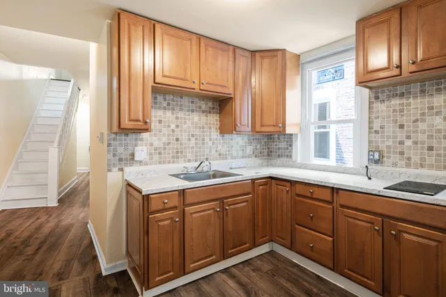 a kitchen with a sink stove and cabinets