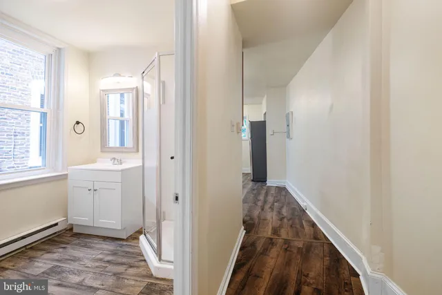 a view of a hallway with closet and bathroom