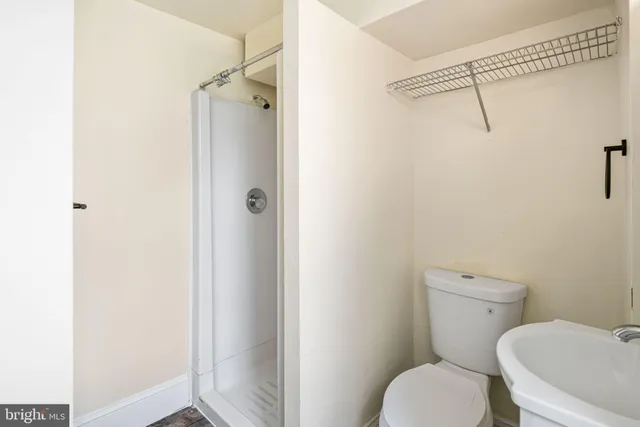 a white toilet sitting next to a bathroom sink