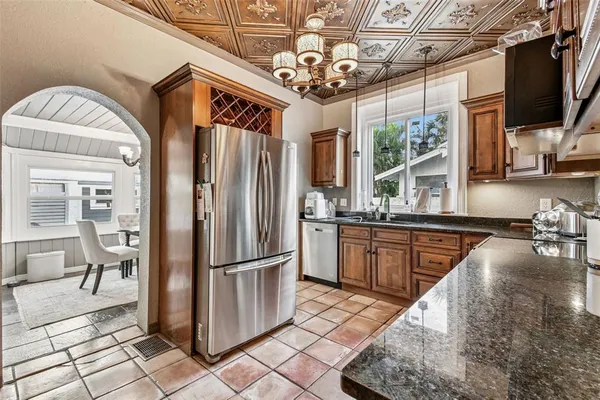 a kitchen with stainless steel appliances granite countertop a refrigerator and a stove top oven