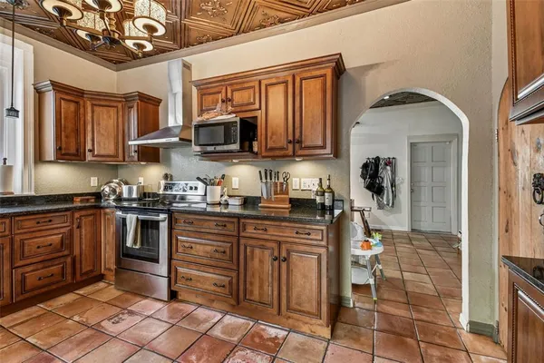 a bedroom with a bed and dresser with mirror