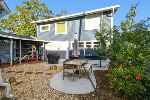 a bedroom with a bed and a flat tv screen on dresser