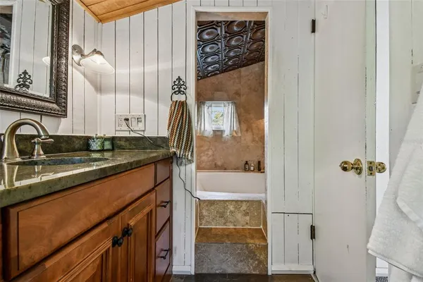 an aerial view of residential houses with outdoor space and trees