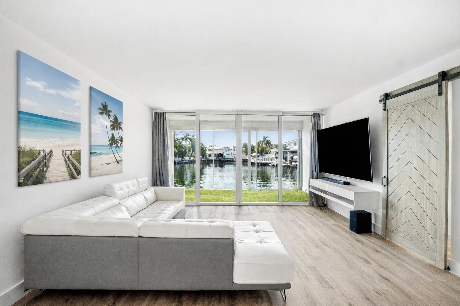 698 Northeast Spanish River Boulevard, Unit 140 Boca Raton, FL 33431 - Photo 5 of 21 a living room with furniture and a flat screen tv