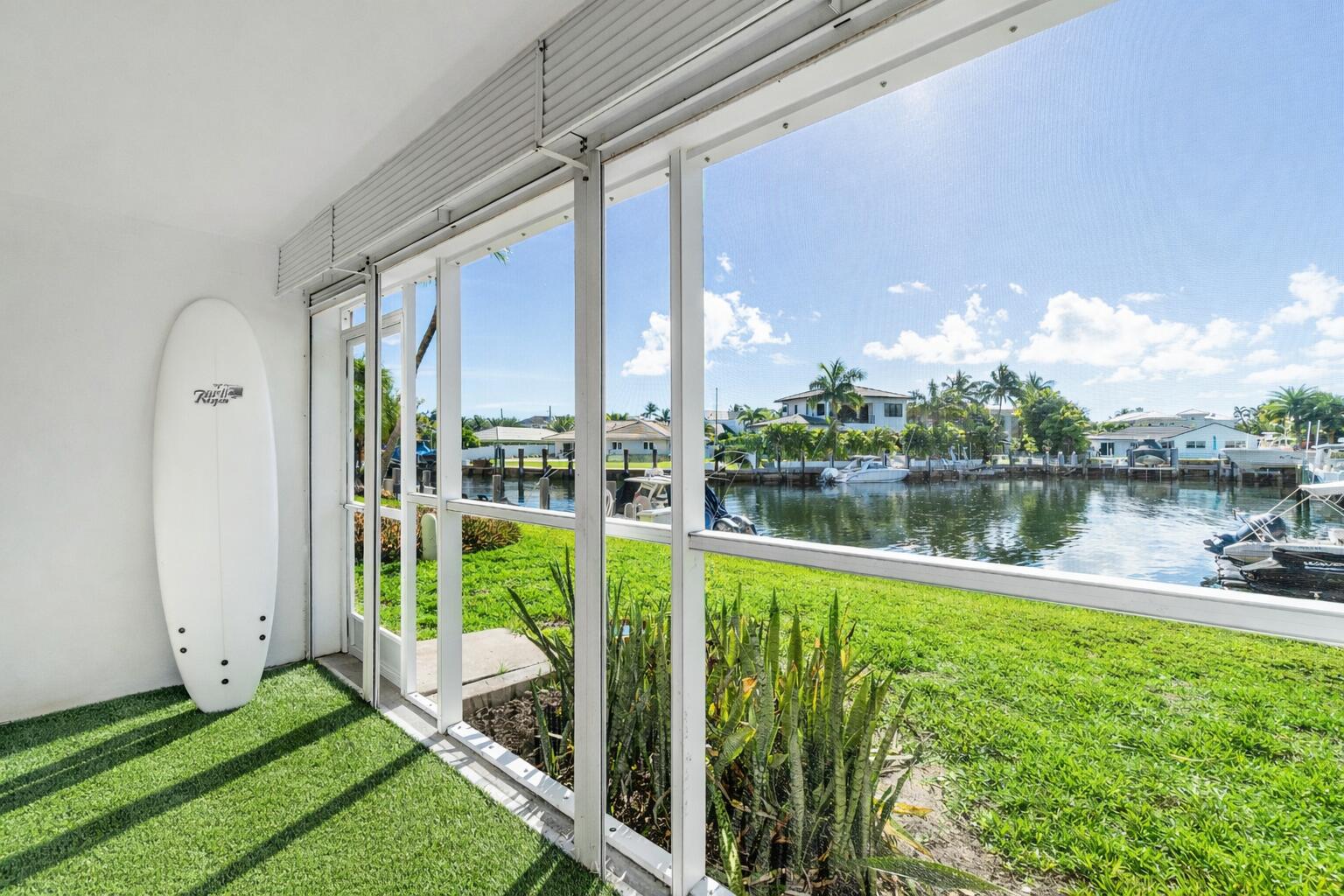 698 Northeast Spanish River Boulevard, Unit 140 Boca Raton, FL 33431 - Photo 10 of 21 a view of a lake with a big yard and potted plants