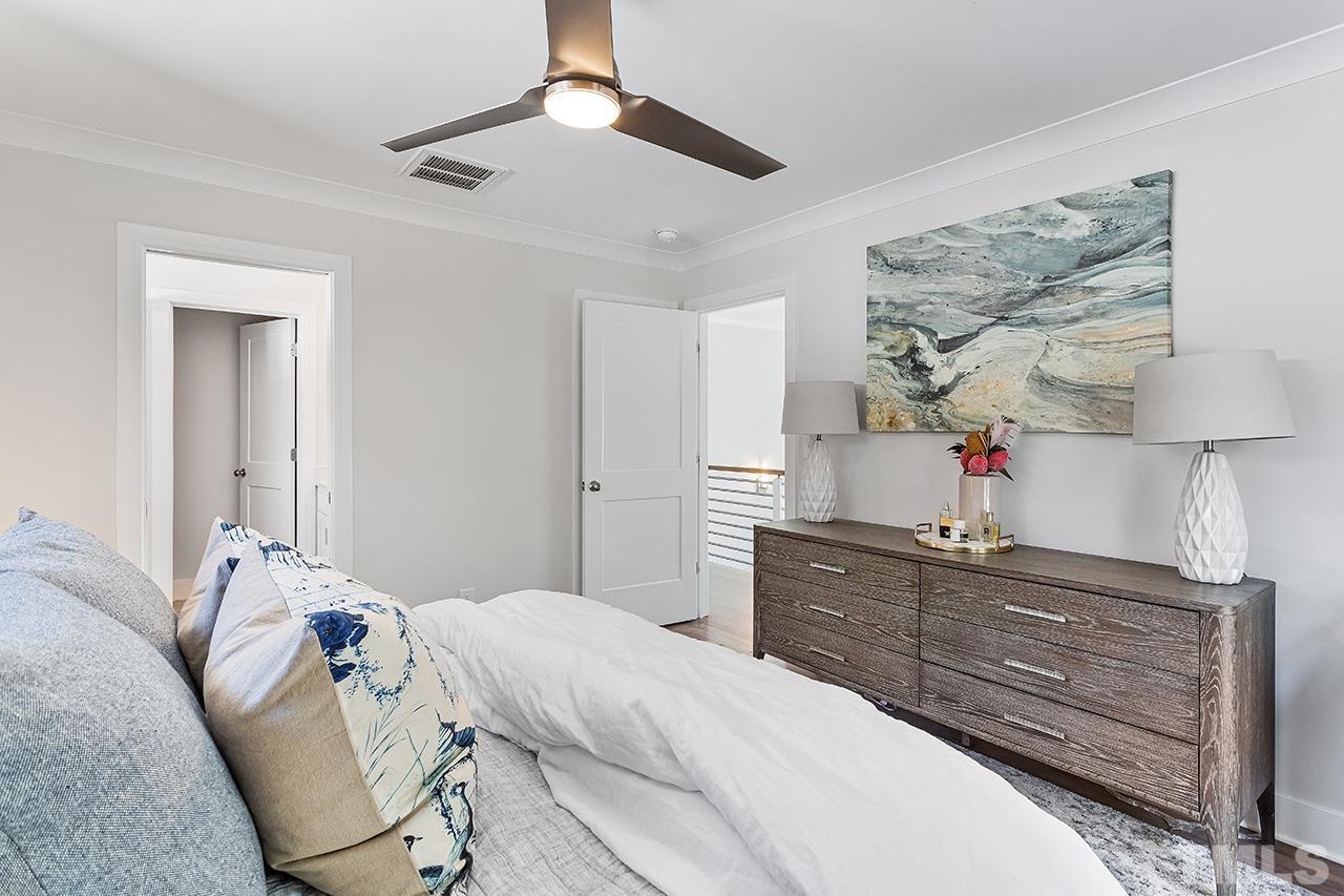 512 Alston Street Raleigh, NC 27601 - Photo 24 of 35 a bedroom with a bed and a chandelier
