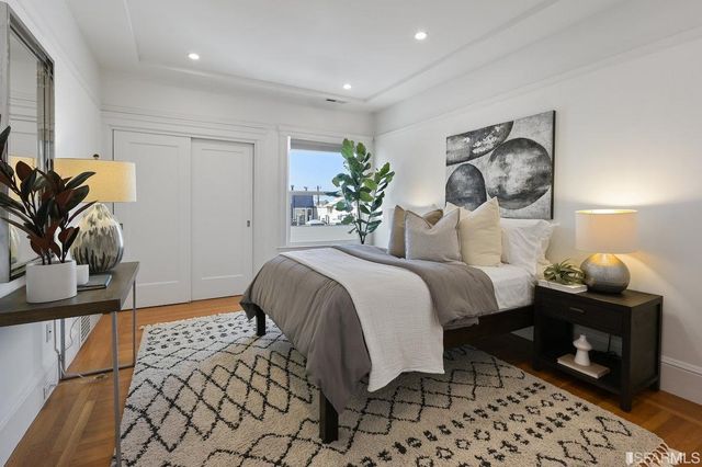 a bedroom with a bed and a potted plant