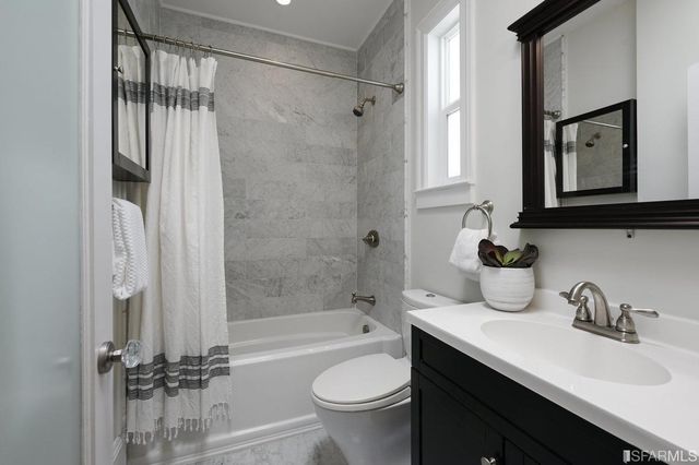 a bathroom with a sink a toilet and a bathtub