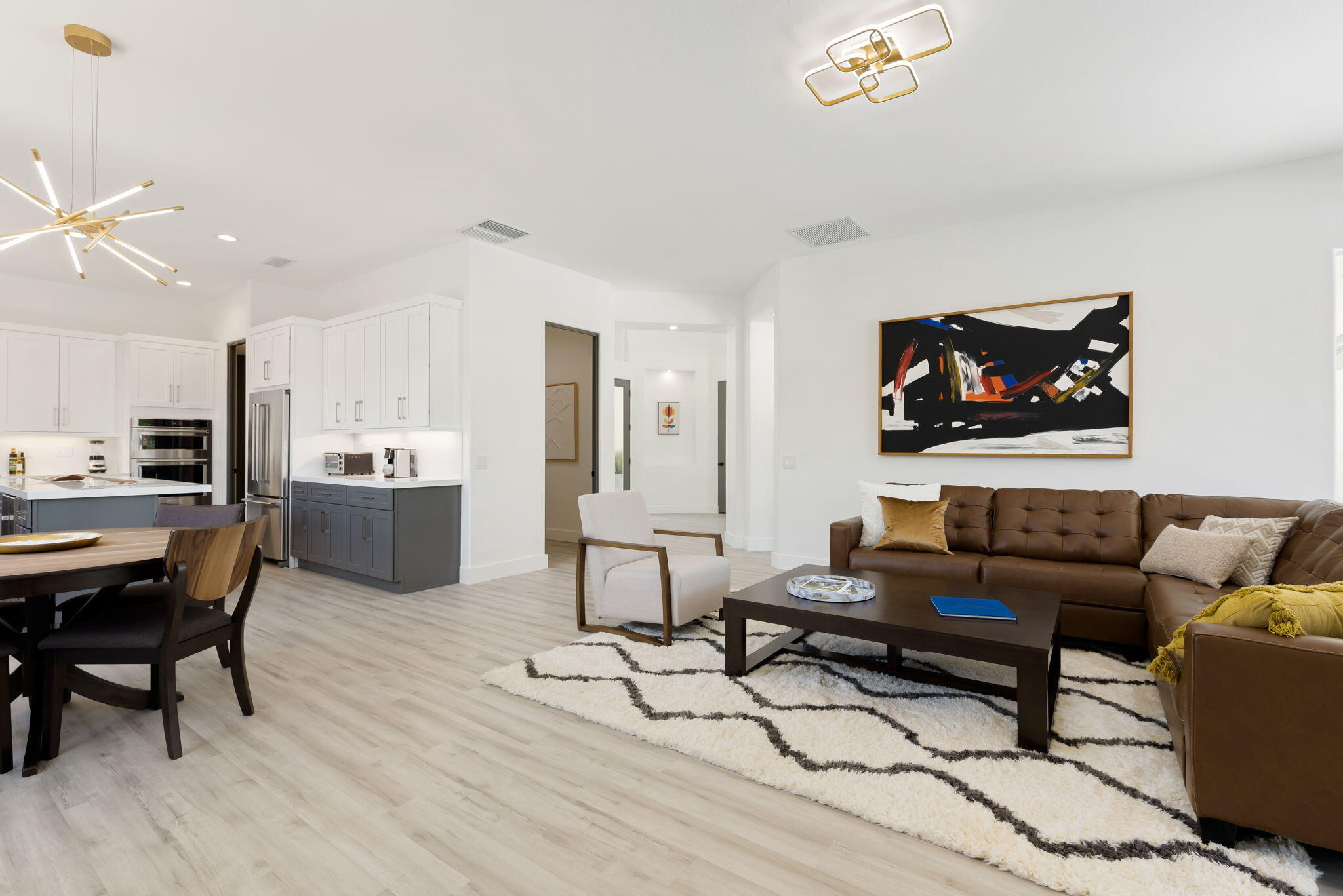a living room with furniture and kitchen view