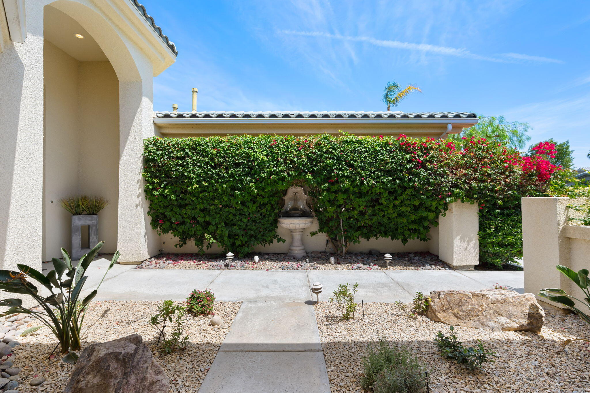 3 King Edward Court Rancho Mirage, CA 92270 - Photo 12 of 57 a view of a garden with a bench in patio