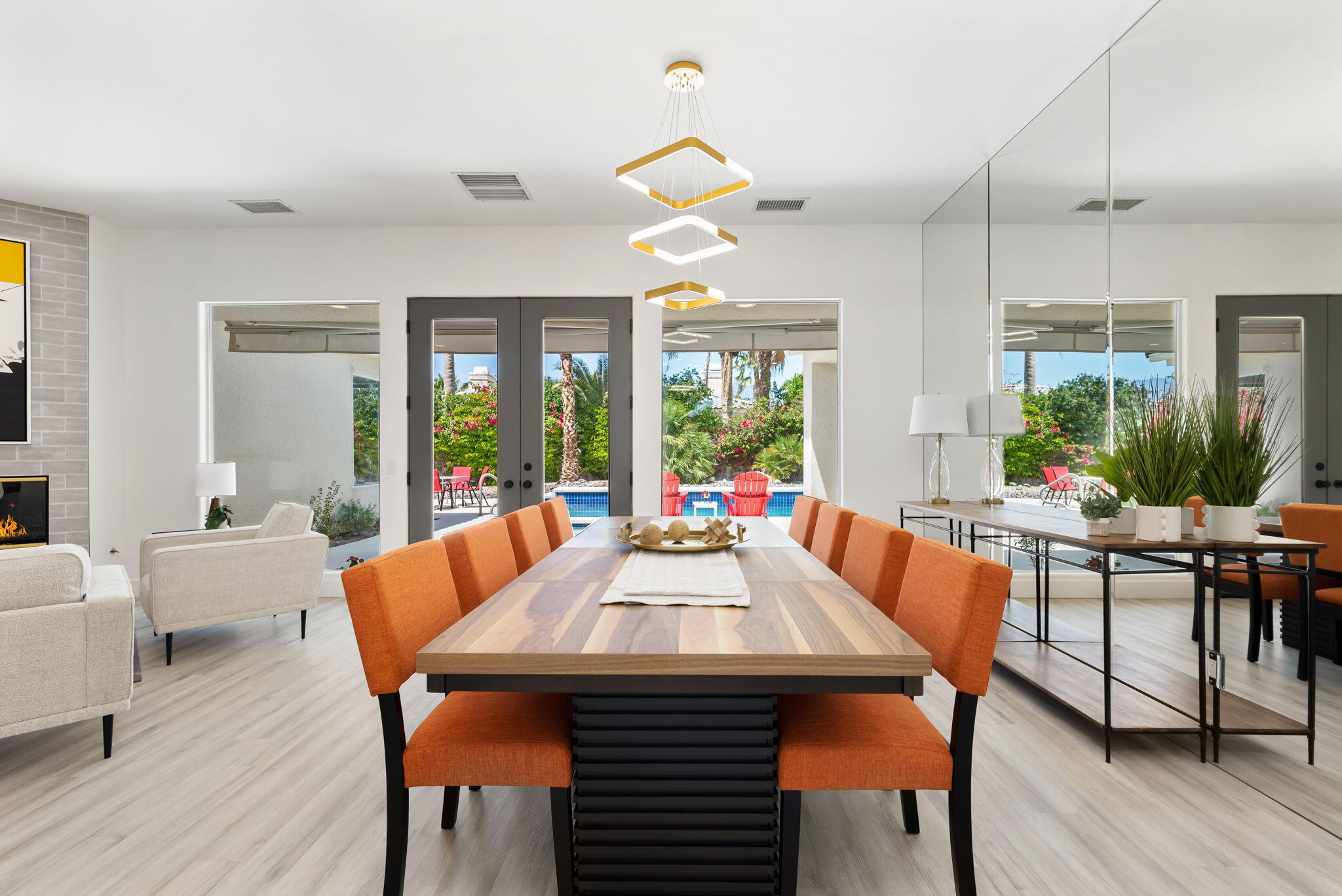 3 King Edward Court Rancho Mirage, CA 92270 - Photo 17 of 57 a dining room with wooden floor a chandelier a glass table and chairs