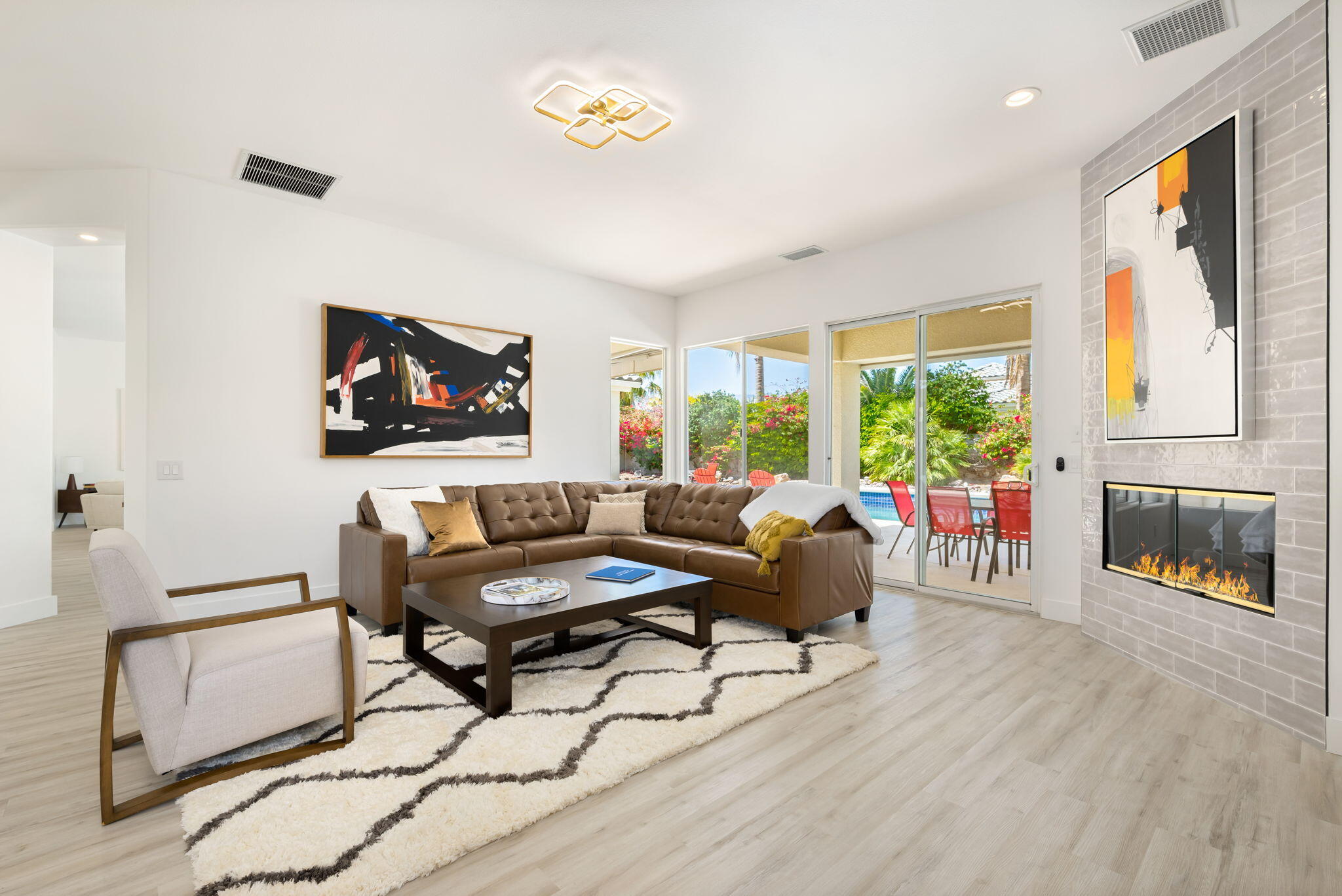 3 King Edward Court Rancho Mirage, CA 92270 - Photo 23 of 57 a living room with furniture a fireplace and a flat screen tv