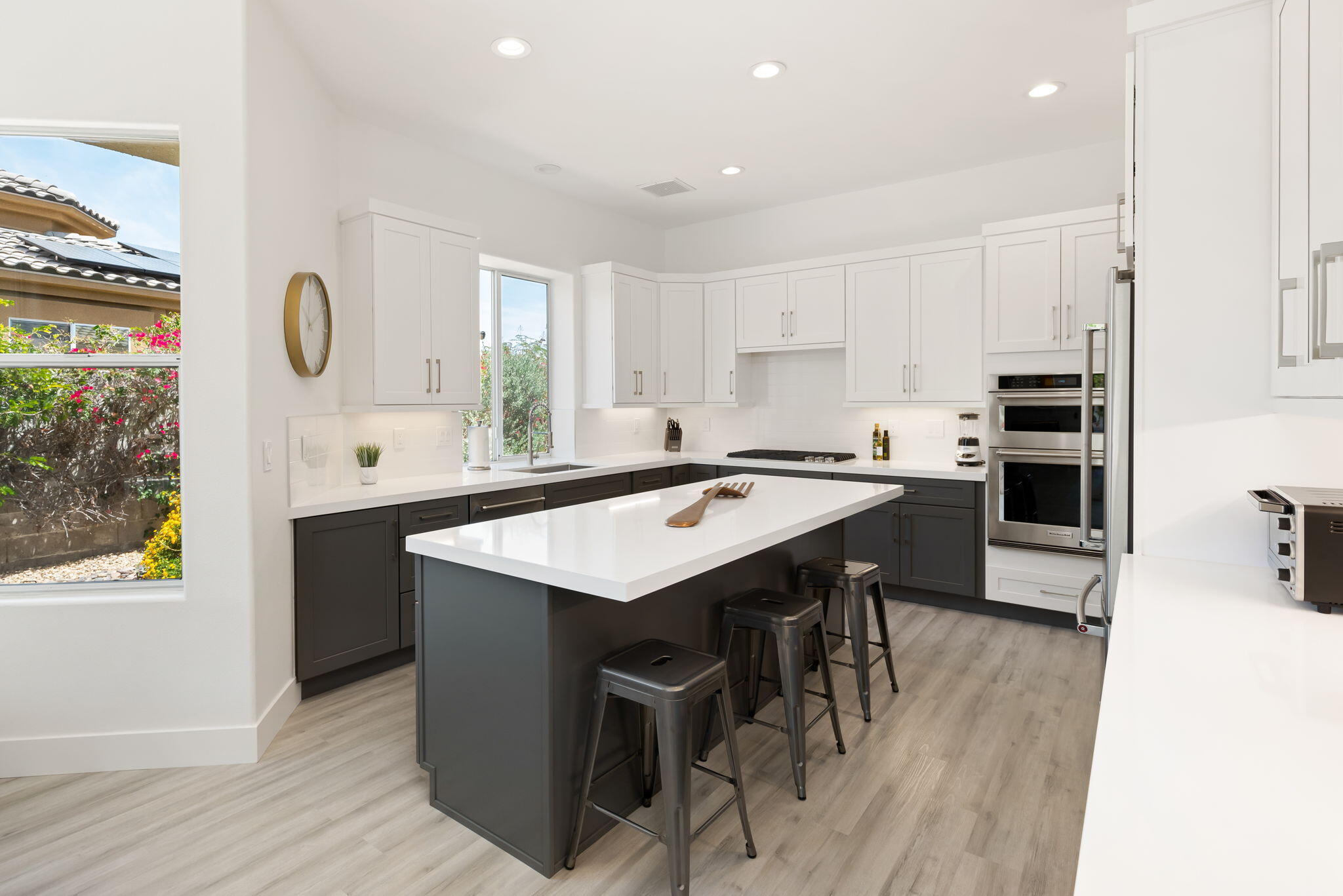 3 King Edward Court Rancho Mirage, CA 92270 - Photo 27 of 57 a kitchen with stainless steel appliances granite countertop a sink a stove and a refrigerator