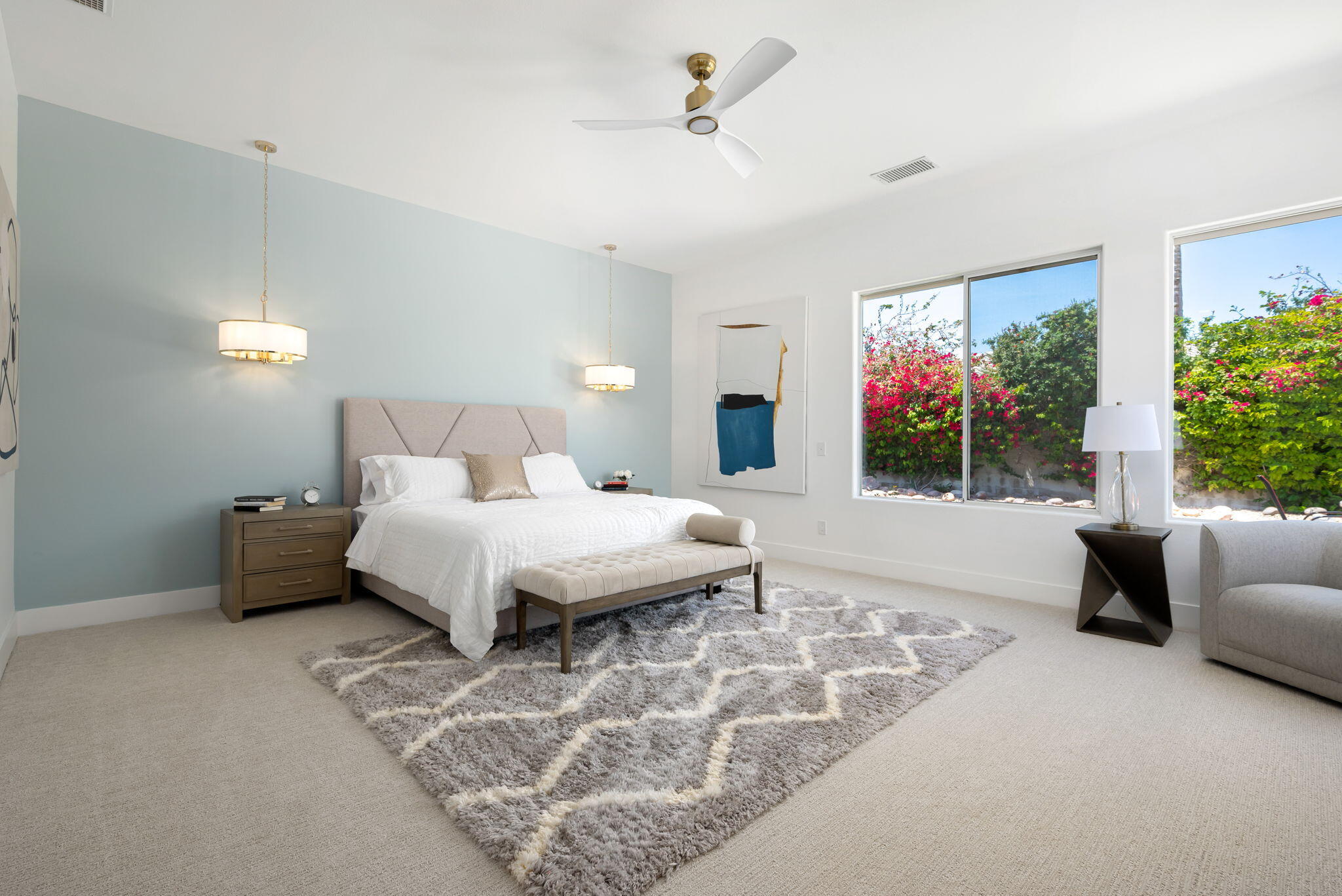 3 King Edward Court Rancho Mirage, CA 92270 - Photo 34 of 57 a spacious bedroom with a bed a couch and a window