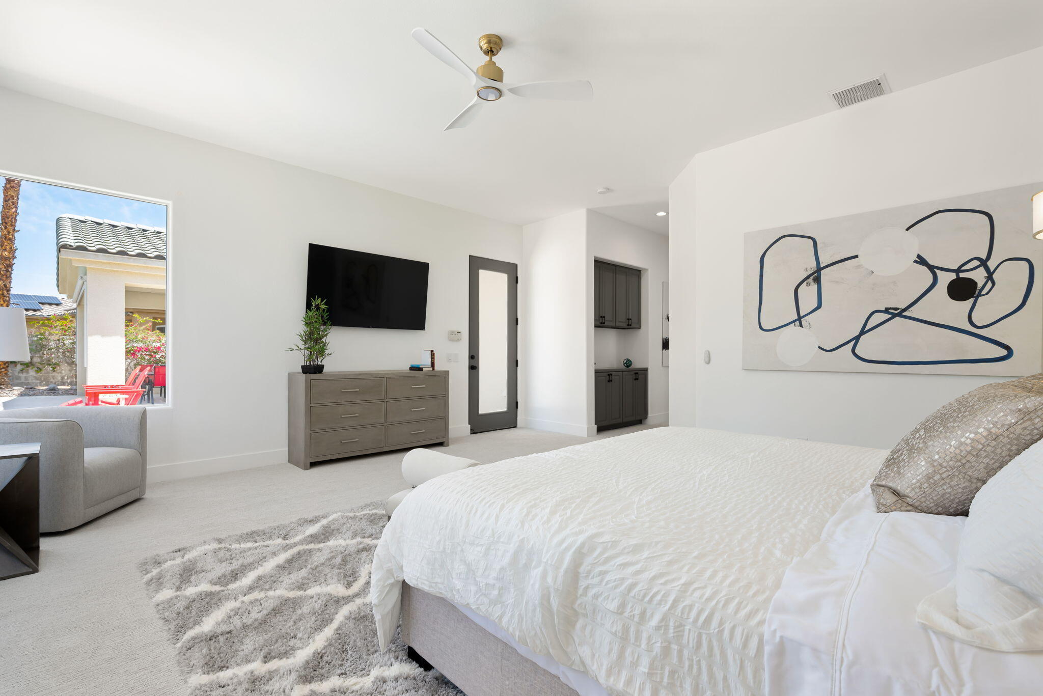 3 King Edward Court Rancho Mirage, CA 92270 - Photo 35 of 57 a bedroom with a large bed and a flat tv screen on dresser
