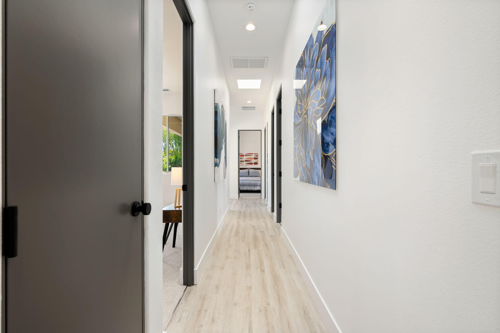 3 King Edward Court Rancho Mirage, CA 92270 - Photo 40 of 57 a view of a hallway with wooden floor and a bathroom