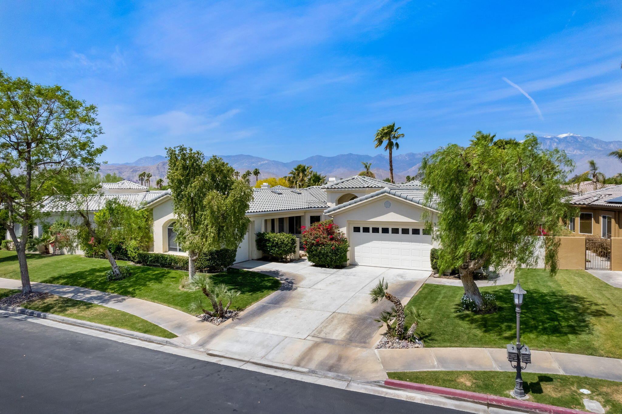 3 King Edward Court Rancho Mirage, CA 92270 - Photo 4 of 57 a front view of a house with a yard and garage