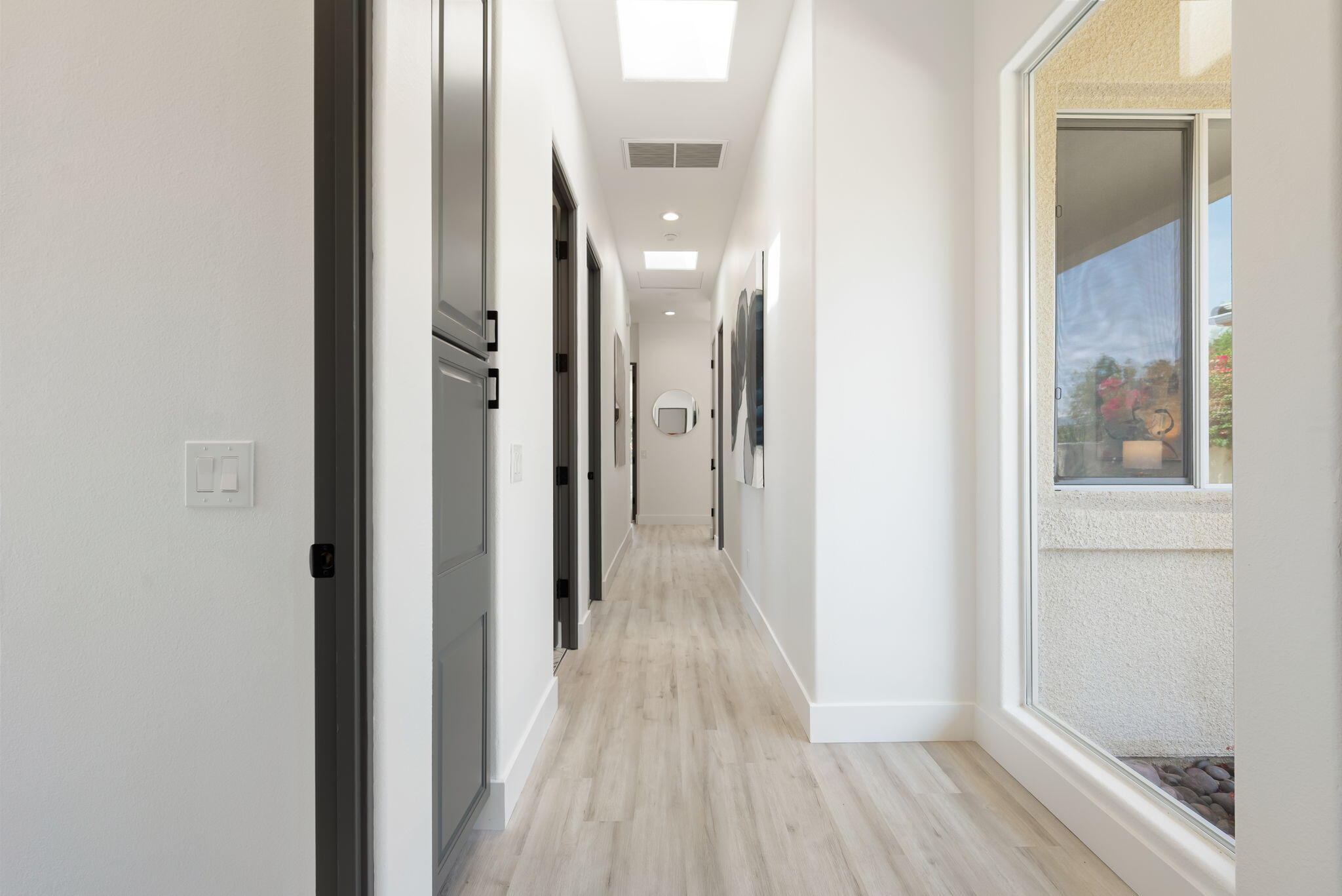3 King Edward Court Rancho Mirage, CA 92270 - Photo 47 of 57 a view of a hallway with wooden floor and a glass door