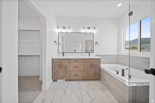 1117 East Shilow Road, Unit 106 Erda, UT 84074 - Photo 9 of 21 Bathroom featuring a double vanity with wood-finish cabinetry, a large frameless mirror, and modern light fixtures