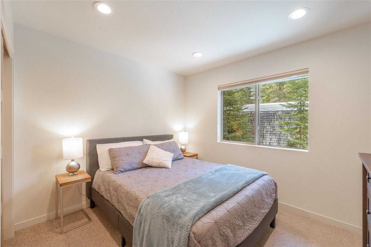 5641 Rhodesia Road Carnelian Bay, CA 96140 - Photo 12 of 21 a bedroom with a bed and window