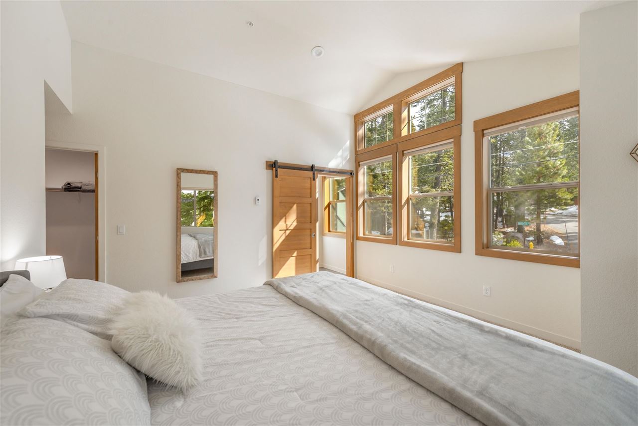 5641 Rhodesia Road Carnelian Bay, CA 96140 - Photo 13 of 21 a bedroom with a large bed and a large window
