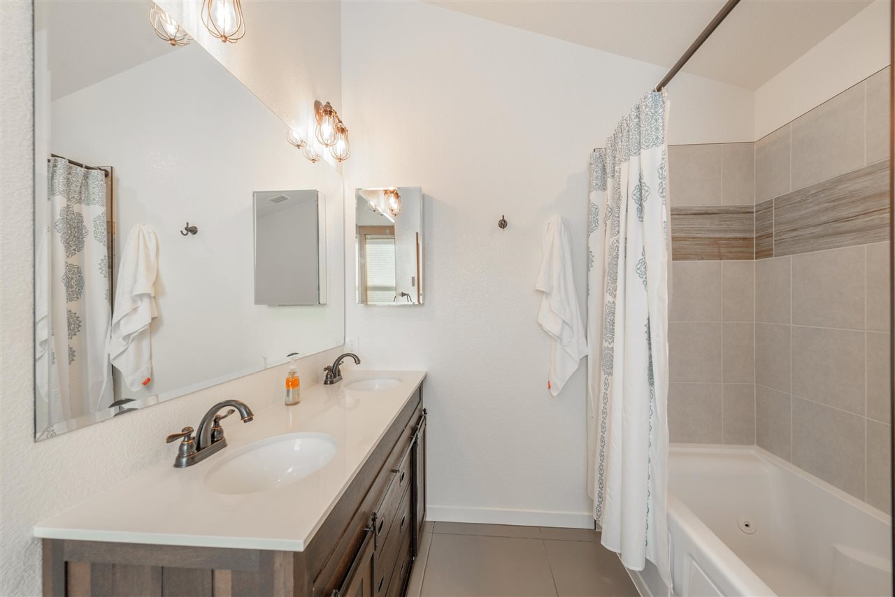 5641 Rhodesia Road Carnelian Bay, CA 96140 - Photo 16 of 21 a bathroom with a sink vanity tub and shower