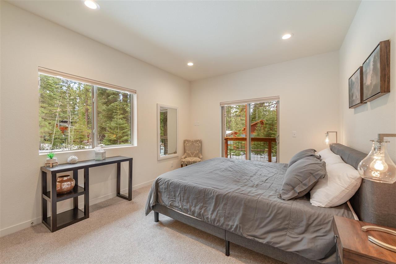 5641 Rhodesia Road Carnelian Bay, CA 96140 - Photo 18 of 21 a bedroom with a bed and a large window