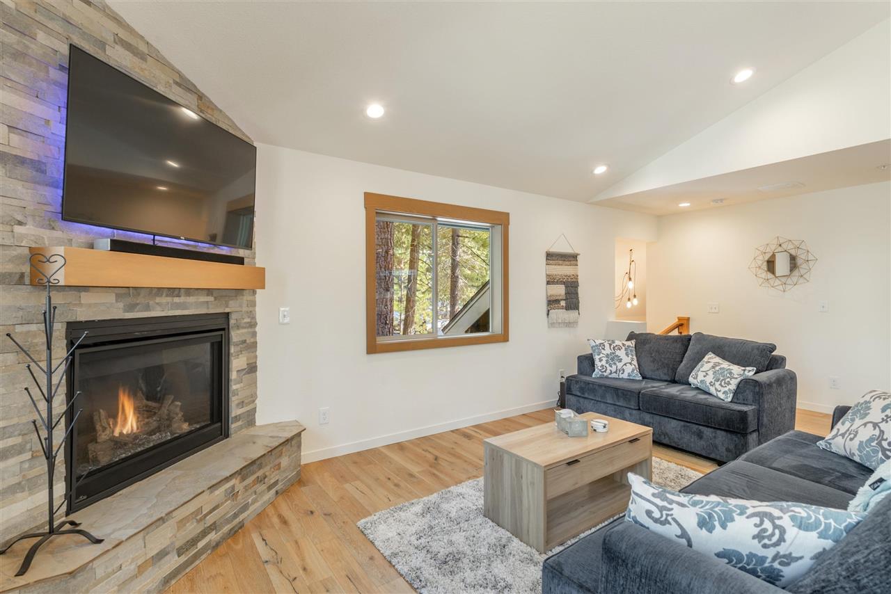 5641 Rhodesia Road Carnelian Bay, CA 96140 - Photo 6 of 21 a living room with furniture and a fireplace