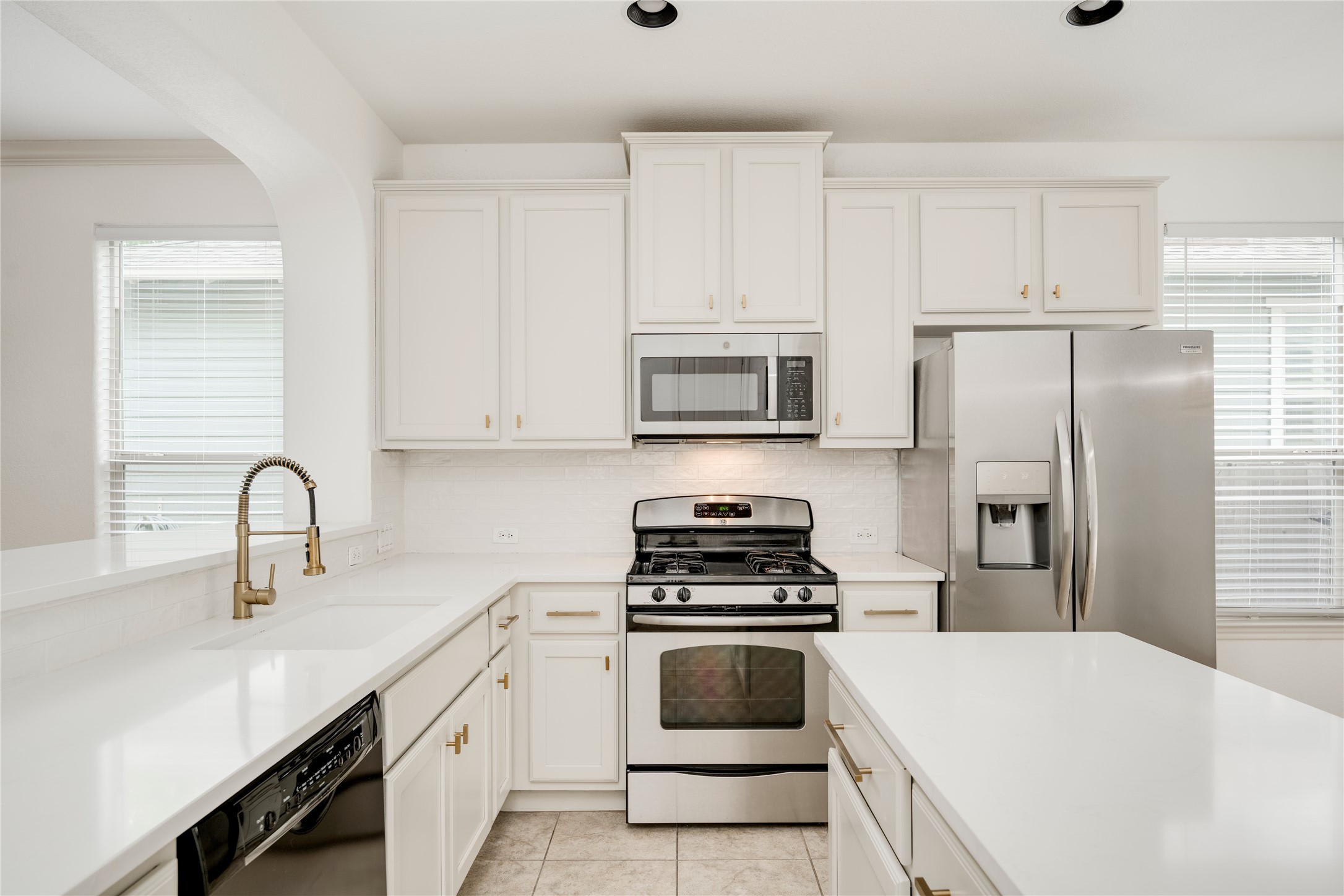 6008 Whipple Way Austin, TX 78745 - Photo 17 of 39 Culinary delights await in this bright kitchen with a convenient center island and modern appliances.
