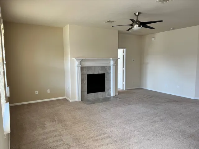 a view of an empty room with a fireplace