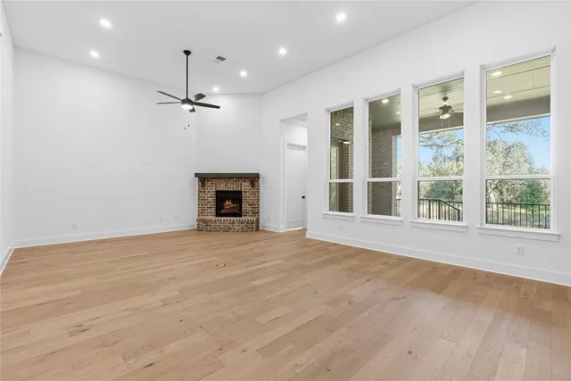 a large kitchen with stainless steel appliances granite countertop a stove and a wooden floors