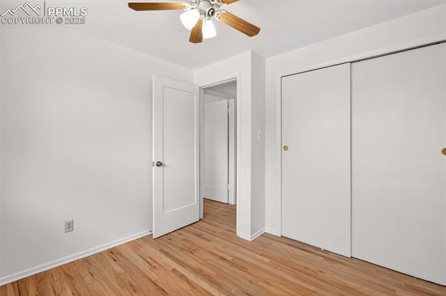 130 South Chelton Road Colorado Springs, CO 80910 - Photo 7 of 17 Front bedroom with light wood-style flooring, a closet, and a ceiling fan