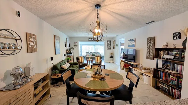 a living room with lots of furniture and a chandelier