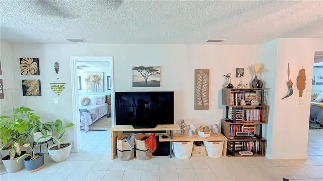 a living room with furniture and a bookshelf
