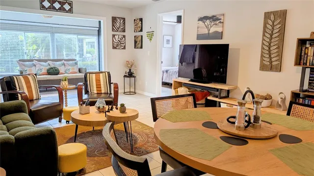 a dining room with furniture and a flat screen tv