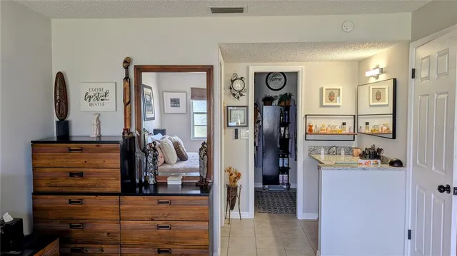 a view of a bedroom with a large bed and dresser