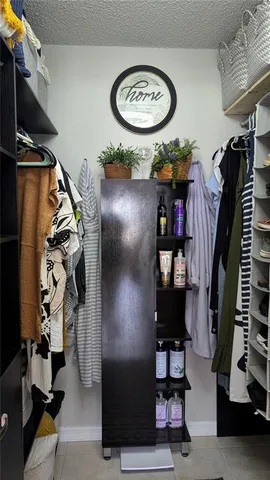 a bathroom with a sink a mirror a toilet and a shower