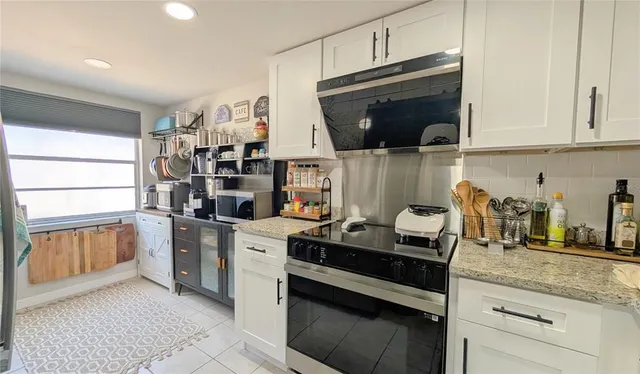 a kitchen with stainless steel appliances a stove microwave and cabinets