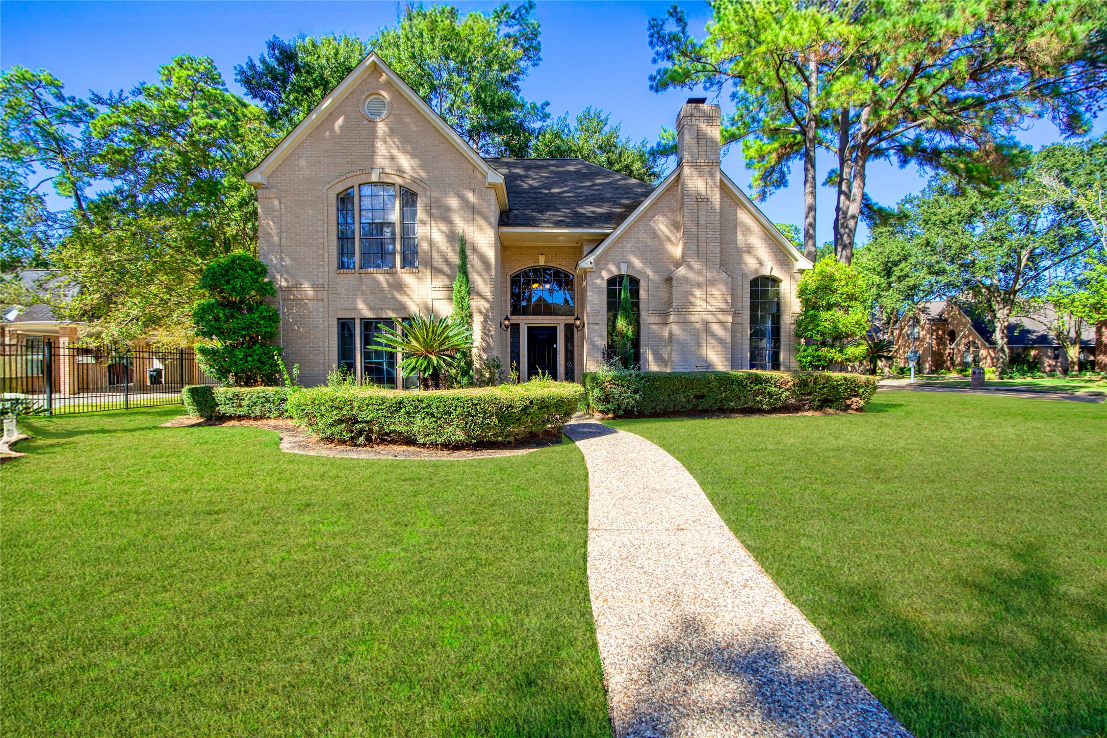 a front view of house with yard and green space