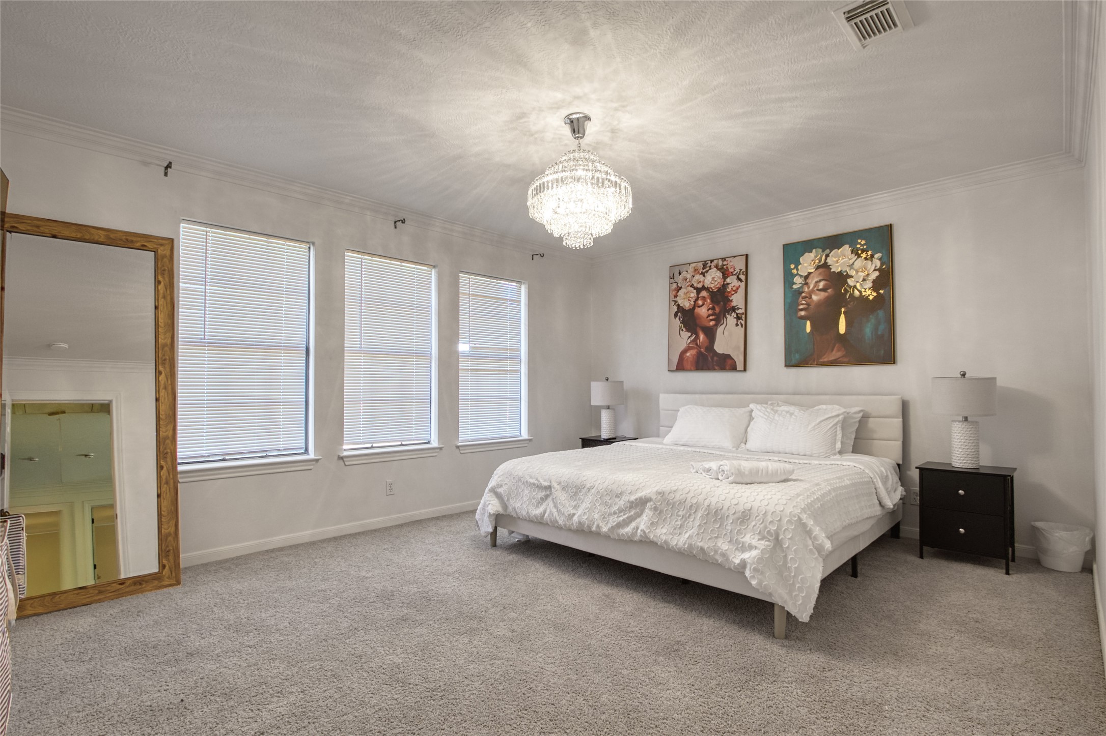 6782 Cutten Parkway Houston, TX 77069 - Photo 16 of 20 a spacious bedroom with a bed painting on wall and windows