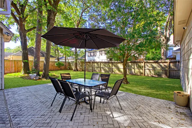a view of a backyard with furniture and a garden