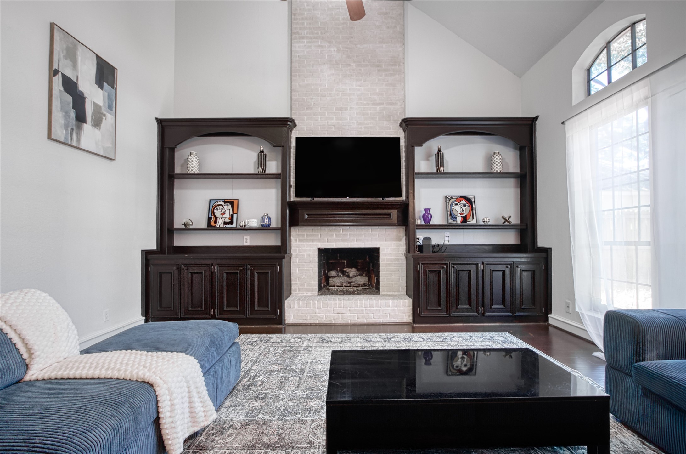 6782 Cutten Parkway Houston, TX 77069 - Photo 7 of 20 a living room with furniture a flat screen tv and a fireplace