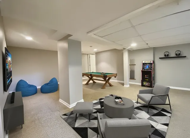 an empty room with wooden floor and bathroom