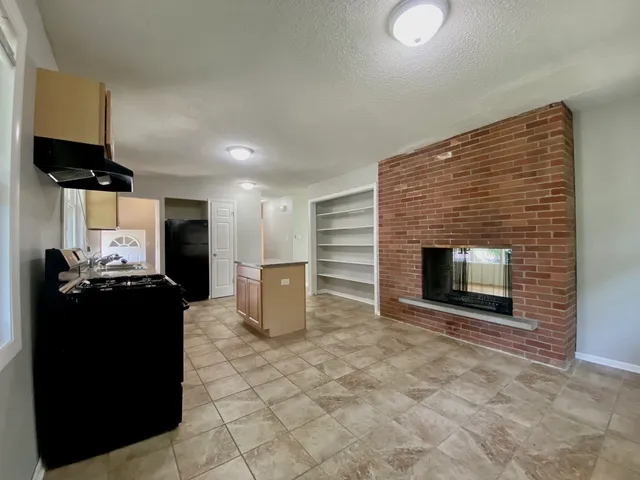 a kitchen with a stove and a refrigerator